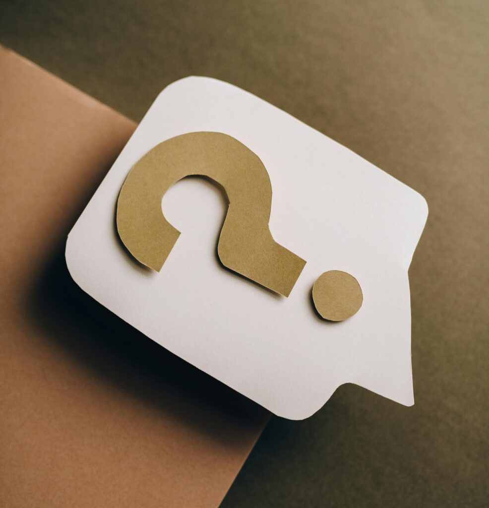 Artistic paper craft of a question mark on neutral background. Ideal for concept themes.